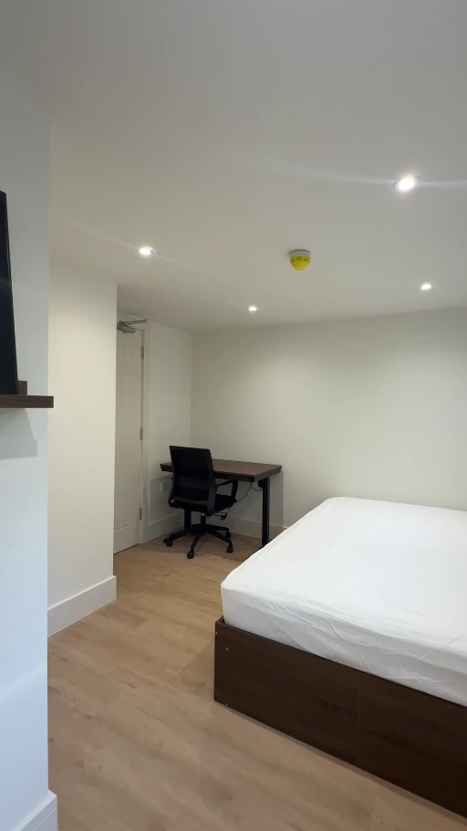 Bedroom with pale freshly painted walls and white ceiling